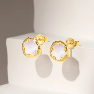 Detail of S925 sterling silver flower stud earrings with white mother of pearl and gold rim