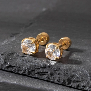 Macro detail of 5mm round zircon stud earring with gold-plated four-prong setting