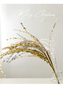 Close-up of glittered Christmas tree branches in gold and silver for holiday decor
