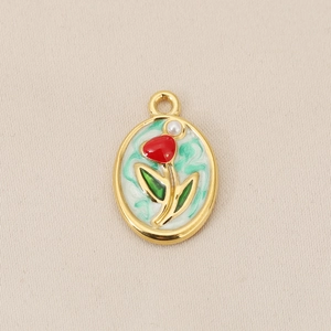 Detail of 18K gold plated tulip pendant with red enamel and small white pearl accent