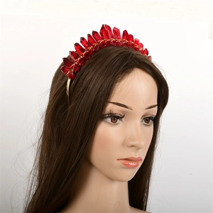 Detail of red pointed crystals fixed with gold wire on a bridal crown headband