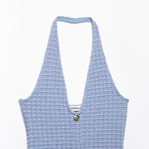 Elegant light blue waffle knit halter dress with a gold button detail on the V-neckline