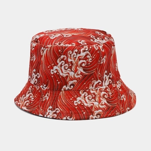Red reversible bucket hat with white Japanese wave pattern print on a grey background