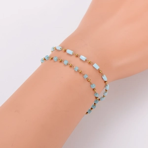 Double-layered stainless steel bracelet with light blue cube beads and polished gold spheres