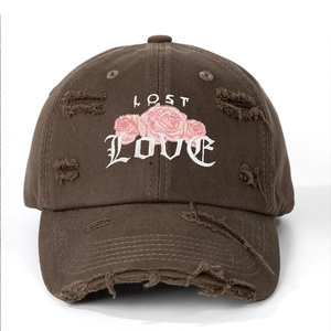Detail of distressed brown cotton baseball cap with pink rose and 'LOST LOVE' embroidery