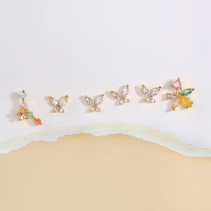 Set of minimalist gold geometric butterfly and flower stud earrings with colorful cubic zirconia