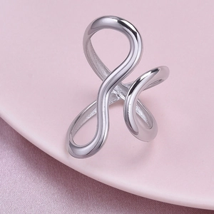 Detailed shot of polished 304 stainless steel ring with abstract curved line design