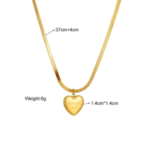 Gold heart pendant snake chain necklace with love you more engraving on white background