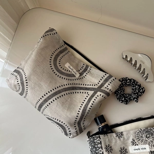 Flat lay of vintage linen cosmetic bags with paisley and geometric patterns