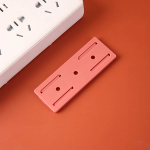 Pink wall-mounted power strip holder made of durable plastic with slide-in slot design