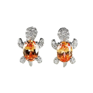 Silver sea turtle stud earrings with oval orange gemstone and white zircon paving