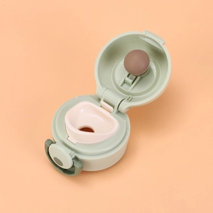 Detail of light green pop-up lid for mini vacuum flask with silicone leak-proof seal