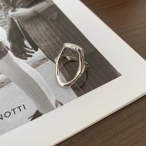 Irregular oval minimalist s925 silver open ring displayed on a fashion magazine
