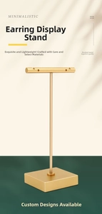 Macro shot of gold brushed metal T-bar earring display stand with thick square base