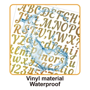 Macro shot of glitter vinyl alphabet stickers showing waterproof feature under water splashes