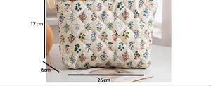 Detailed view of floral quilted toiletry bag with dimensions 26cm x 17cm x 6cm