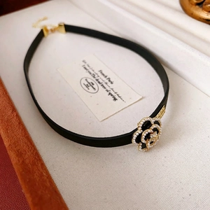 Elegant gold plated choker featuring a black camellia flower pendant with white pearls