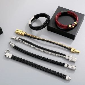 Detail of woven leather bracelets with polished stainless steel magnetic clasps for men