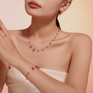Detailed view of pink natural crushed stone necklace and bracelet set on model