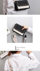 Close-up of contrast black and white crossbody bag with floral pattern wide strap