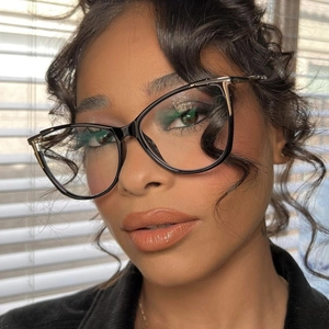 Close-up of black cat-eye glasses with metal hinges on a model with soft lighting