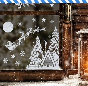 Christmas window decals with Santa, reindeer and snowflakes on a cozy snowy window scene
