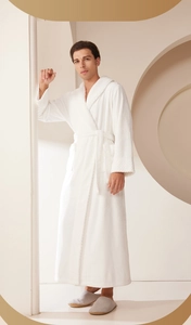 Detail of white flannel bathrobe featuring a quilted cuff and soft plush texture