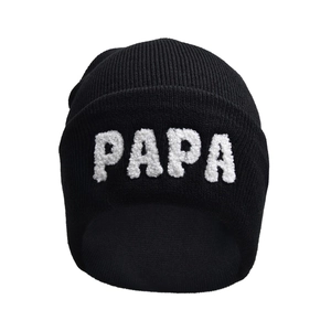 Black ribbed knit beanie featuring white bouclé PAPA letter embroidery on folded cuff
