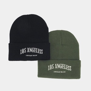 Black and olive green knitted beanies featuring vintage Los Angeles letter embroidery