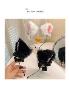 Detail of plush cat ear headband with ribbon bows and golden bells on a desk