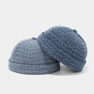 Close-up of vintage washed denim docker hats showing textured fabric and stitching details