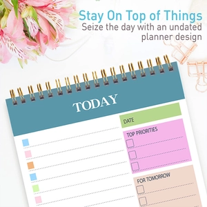 Detailed view of an undated daily planner featuring spiral binding and functional sections