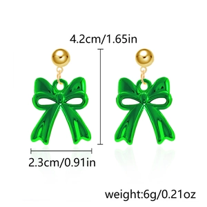 Detail view of green resin bow earrings with dimensions 4.2cm height and 2.3cm width