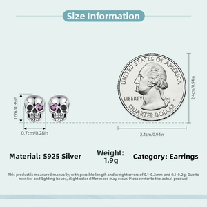 Detail view of S925 silver skull earrings with purple zircons next to a US quarter coin