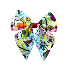 Close-up of colorful Halloween ribbon bow with pumpkin ghost and spider web patterns