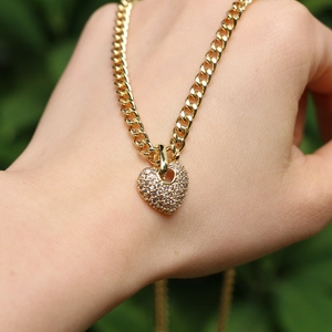Gold heart pendant necklace with micro-paved zircons on a classic Cuban chain