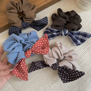 Detail shot of assorted bow scrunchies in polka dots and plaid fabric textures