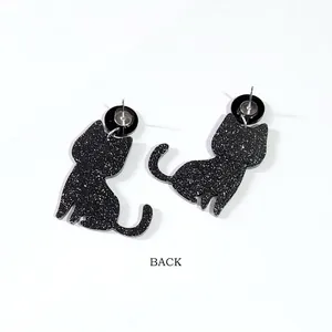 Back view of Halloween black cat skeleton stud earrings with silver glitter finish