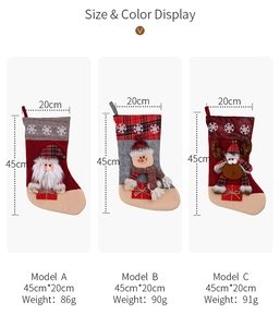 Detail view of large Christmas stockings with snowflake embroidery and plush 3D characters