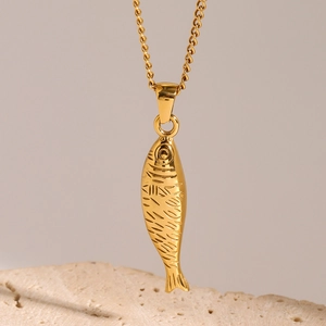 Elegant gold fish pendant necklace in stainless steel with a textured ocean design