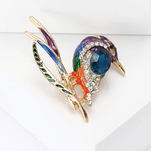 Vibrant woodpecker brooch with enamel details and rhinestones on a gold-plated base