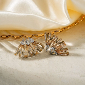 Elegant tiered sunburst zircon stud earrings with teardrop center on silk backdrop