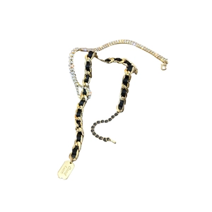 Exaggerated golden leather chain necklace with rhinestone detail and Good Luck tag