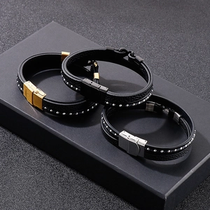 Close-up of multilayer leather bracelets with silver rivets and metal clasps on gift box