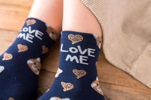 Detail of navy blue cotton crew socks featuring Love Me text and cartoon panda pattern