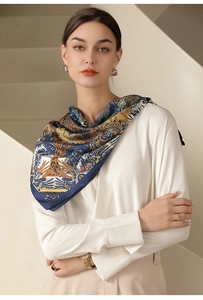 Detail of silk-like neckerchief with elegant navy and gold floral print on a model