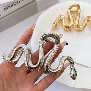 Elegant gold and silver snake shaped metal hair claw clips for women with a polished finish