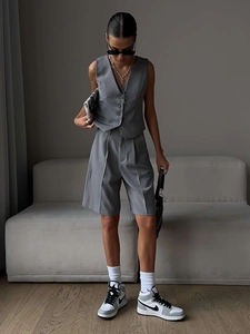 Detail of grey minimalist V-neck vest and matching bermuda shorts set for women
