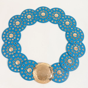 Detail of blue leather disc belt with ornate gold floral buckle on a white background