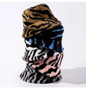 Close-up of fluffy zebra print bucket hats in yellow, blue, pink, and grey colors